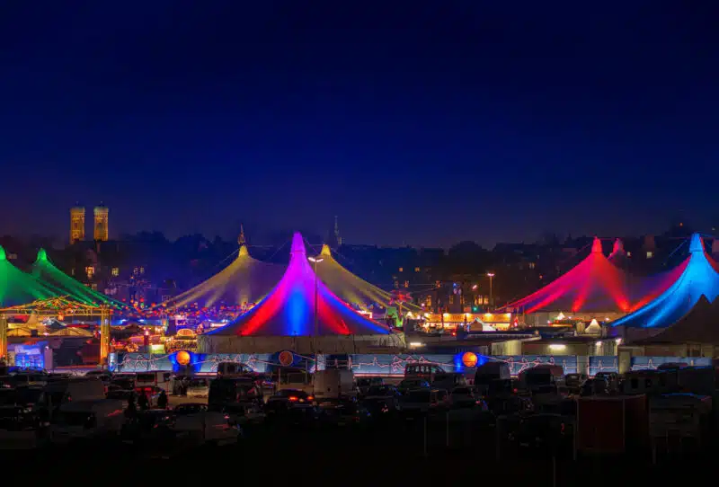 Tollwood's winter festival enchants with its colorfully illuminated tent tops on the Theresienwiese.